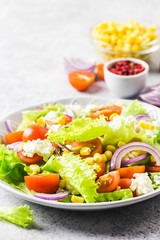 Tomato goat cheese corn salad with olive oil mustard vinaigrette. Selective focus, space for text.