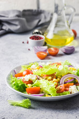 Tomato goat cheese corn salad with olive oil mustard vinaigrette. Selective focus, space for text.