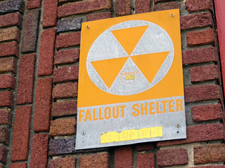 Fallout shelter sign on brick wall