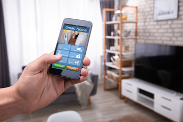 Man Holding Cellphone With Smart Home Application