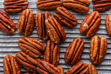 delicious pecan nuts on a rustic wooden background