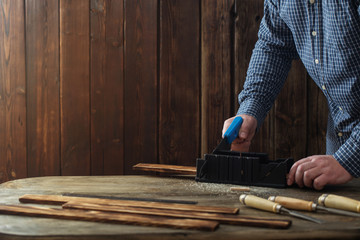 carpenter working with tools on wooden background