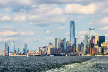 Fototapeta na wymiar Manhattan skyline with One World Trade Center and surrounding buildings viewed from the waters of The Upper New York Bay