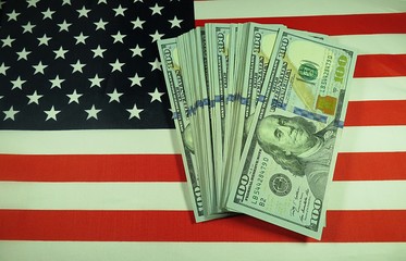 American dollars on national flag background, closeup 