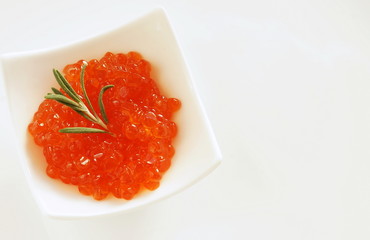 red caviar in small bowls on white background. top view.copy space