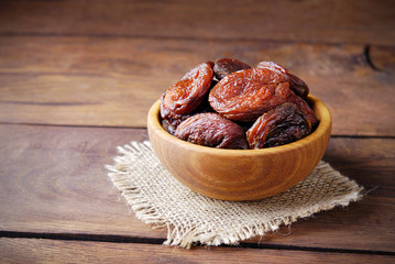 Dry apricot and nuts in a wooden bowl.