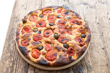 Focaccia typical of Bari Italy with tomatoes and olive