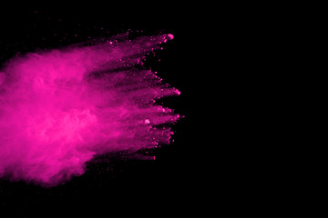 Pink powder explosion on black background. Colored cloud. Colorful dust explode. Paint Holi.