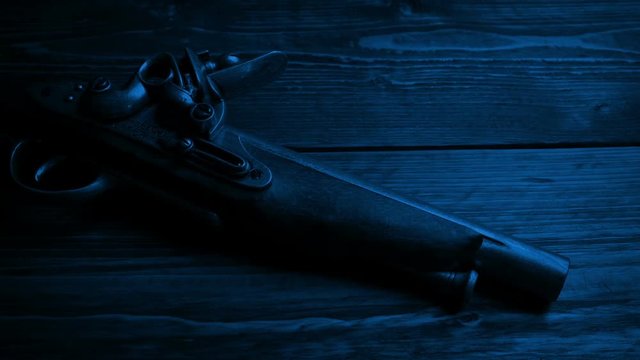 Old Pistol Gun On Table In The Dark