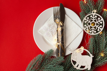 Served Christmas table scratched with decorative symbols on a red background
