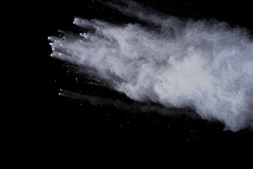 White powder explosion on black background. Colored cloud. Colorful dust explode. Paint Holi.