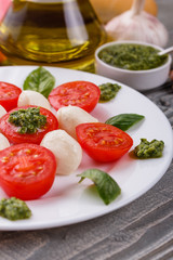 Caprese salad on a wooden rustic background