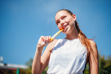 athletic sports young woman Keeps tooth chocolate bar