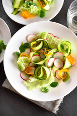 Vegetable salad from zucchini, radish, greens