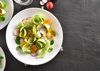 Healthy vegetable salad on dark background