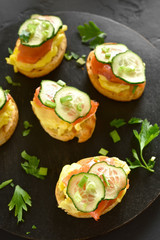 Toasted bread with salmon, scrambled eggs and cucumber