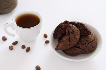 Chocolate cookies and coffee in small cup on a white background - 237777888
