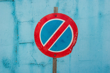 no parking traffic sign on turquoise painted wall