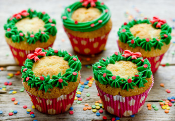 Christmas wreath cupcakes, homemade cupcakes decorated for winter holidays, traditional sweet treat for kids