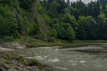 Fototapeta premium Dark grey morning near Lesnicky creek and Dunajec river confluence