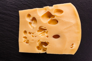 Piece and slices of cheese on a white background