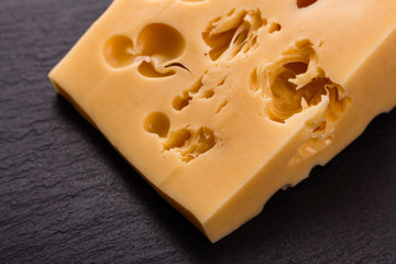 Piece and slices of cheese on a white background