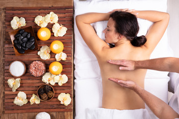Obraz na płótnie Canvas Therapist Massaging Woman's Back