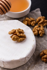 delicious creamy camembert cheese on a wooden rustic background