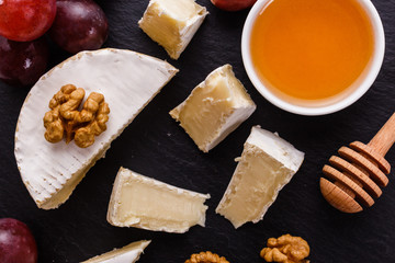 delicious creamy camembert cheese on a wooden rustic background