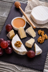delicious creamy camembert cheese on a wooden rustic background