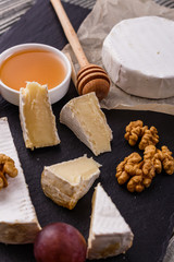 delicious creamy camembert cheese on a wooden rustic background