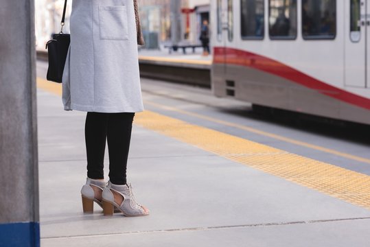 Woman standing on platform at station