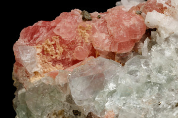 Macro of the mineral stone Rhodochrosite with fluorite on a black background