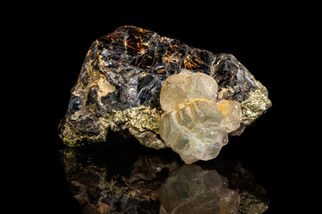 Macro of a mineral stone Sphalerite with fluorite and pyrite on a black background close up