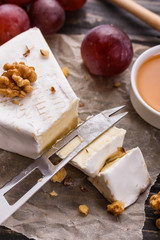 delicious creamy camembert cheese on a wooden rustic background