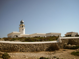 Fototapeta na wymiar Portugal Light House along the coast in white color and blue sky background