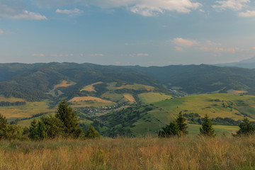 Evening in national park Pieniny with sunny shine over green meadows