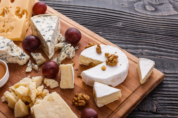 set of different cheeses on a wooden rustic background