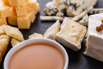 set of different cheeses on a wooden rustic background