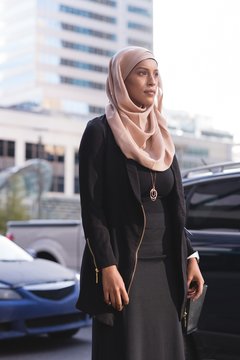 Hijab woman walking in city street
