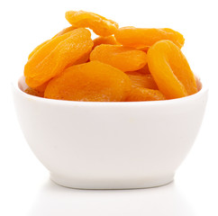 Dried apricots in bowl on white background isolation