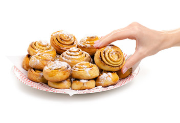 Homemade buns on a plate in hand on a white background. Isolation
