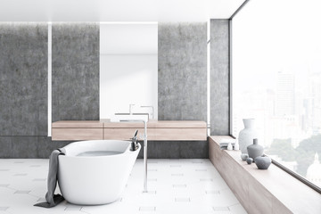 Obraz na płótnie Canvas Concrete bathroom, white tub and sink