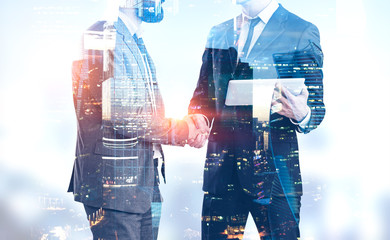 Businessmen shake hands in Moscow city