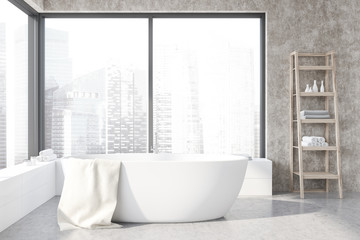 Close up of tub in concrete bathroom