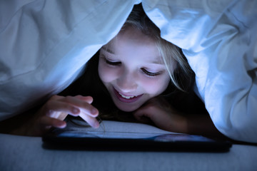 Close-up Of A Happy Girl Using Digital Tablet