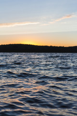Sunset over lake waves