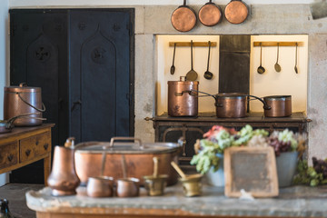 Fototapeta na wymiar Copper pots in medieval kitchen