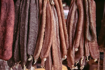 Sujuk and beef jerky hangs on a counter in the street market