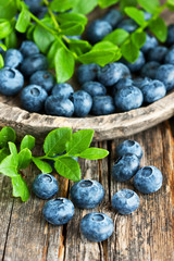 Blueberries with leaves on  old wooden table